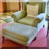 F38. Green upholstered chair and ottoman. Chair: 40”h x 38”w x 35”d Ottoman: 17”h x 31”w x 20”d 